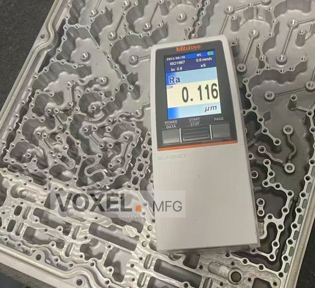 Surface roughness tester showing Ra 0.116 on a CNC machined RF cavity filter for ultra-low PIM performance